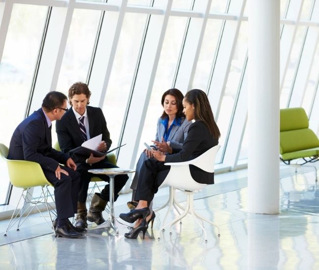 Four Business people Having Meeting In Modern Office